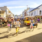 Mackinac Island, Michigan, August 8, 2016: Vacationers take on Market Street on Mackinac Island that is lined with shops and restaurants. No motorized vehicles are allowed on the island.
599741930
Vacationers cycling and walking along Market Street on Mackinac Island in Michigan.