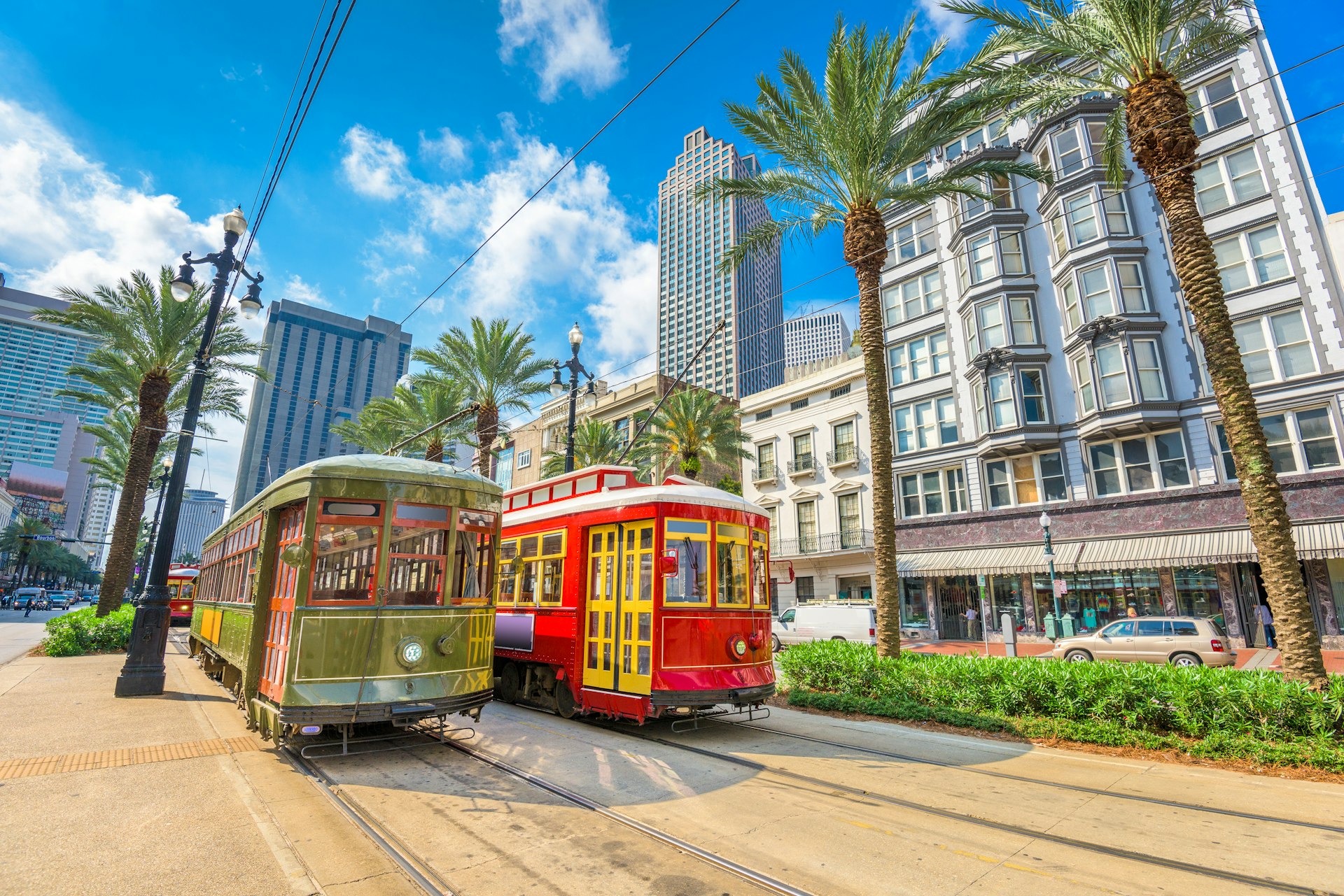 Two of New Orleans' iconic street cars backed by the glass skyscrapers of the city's Central Business District