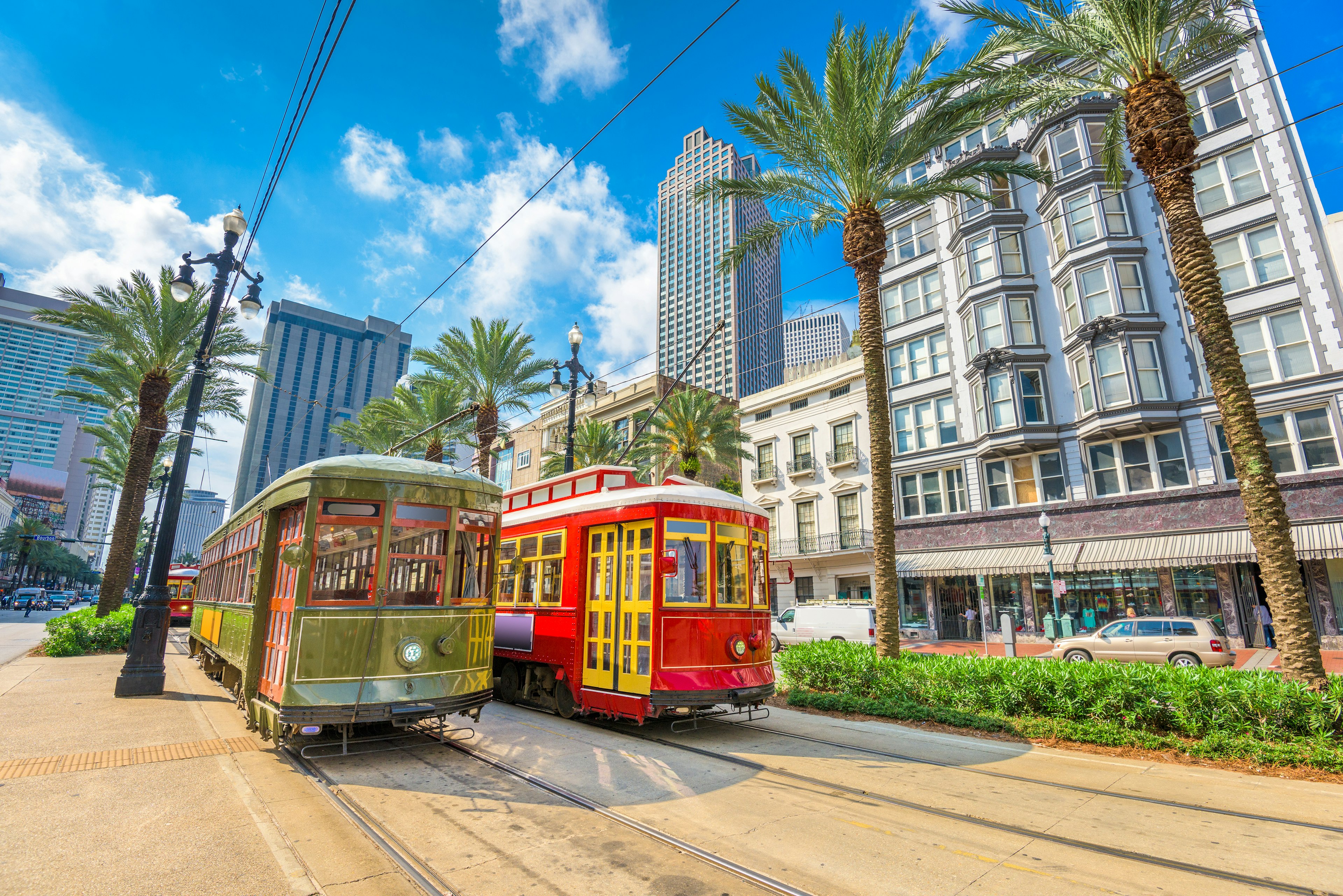 Two of New Orleans' iconic street cars backed by the glass skyscrapers of the city's Central Business District