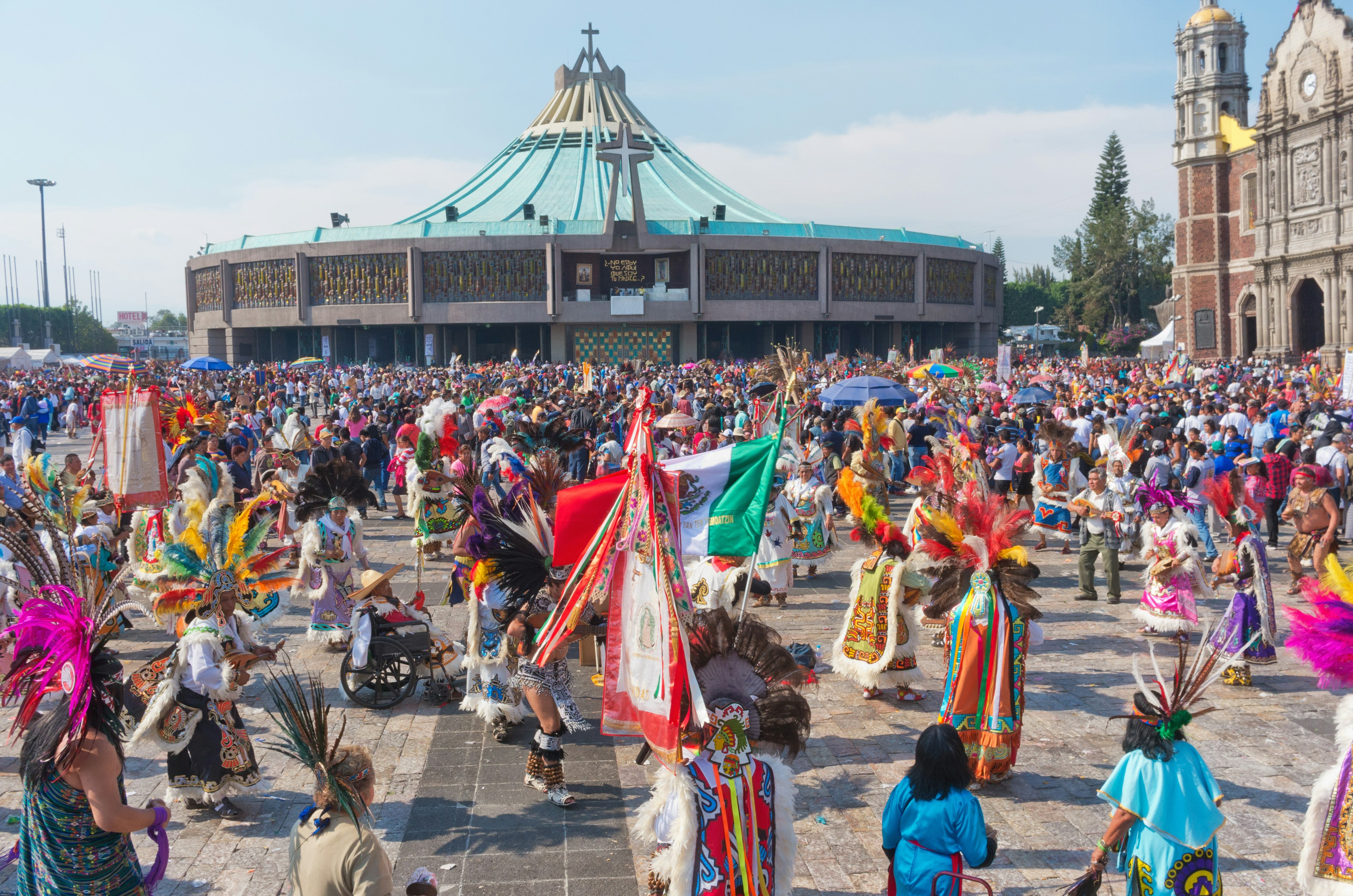 Pilgrims and celebrants in traditional costumes celebrate the day of the Virgin of Guadalupe in the Plaza Mariana, Basílica de Guadalupe, Mexico City, Mexico