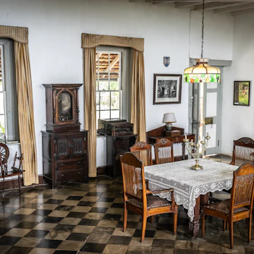 Vintage furniture in dining room area of Greenwood Great House.