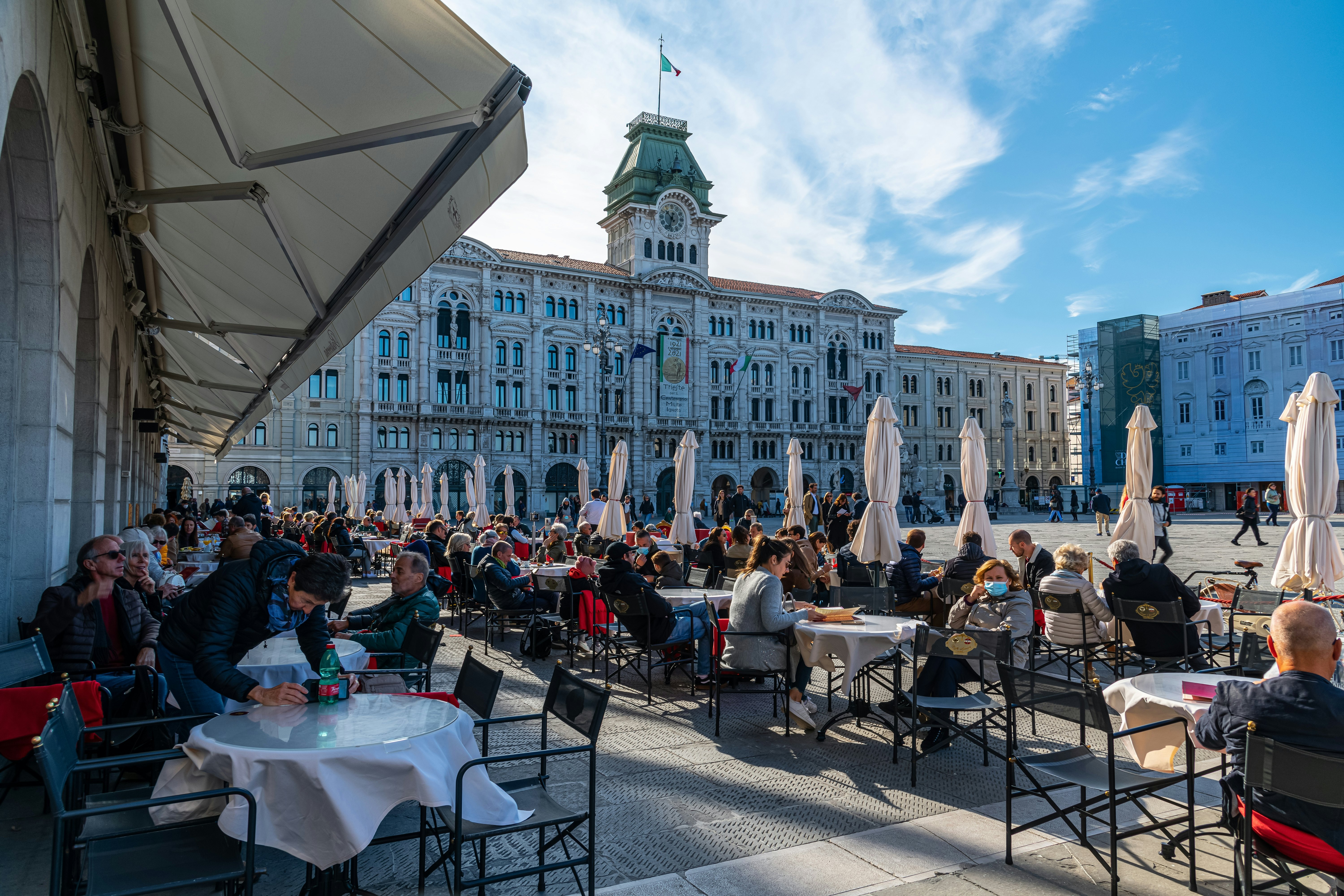 People enjoying coffee at a famous coffeeshop at the Piazza dell’Unità d’Italia, the main square in Trieste.