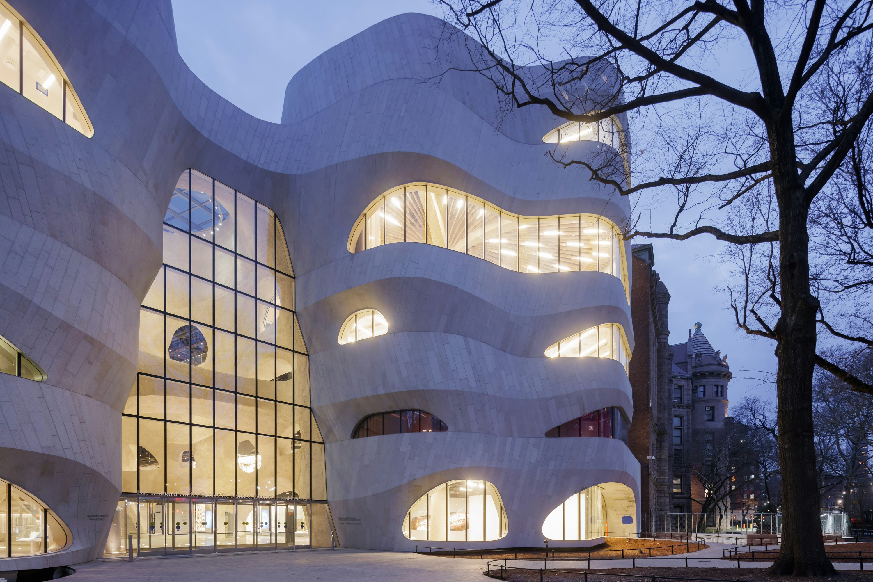 At dusk, the curved windows of the Richard Gilder Center for Science, Education, and Innovation exude an inviting soft glow, American Museum of Natural History, New York City, New York, USA