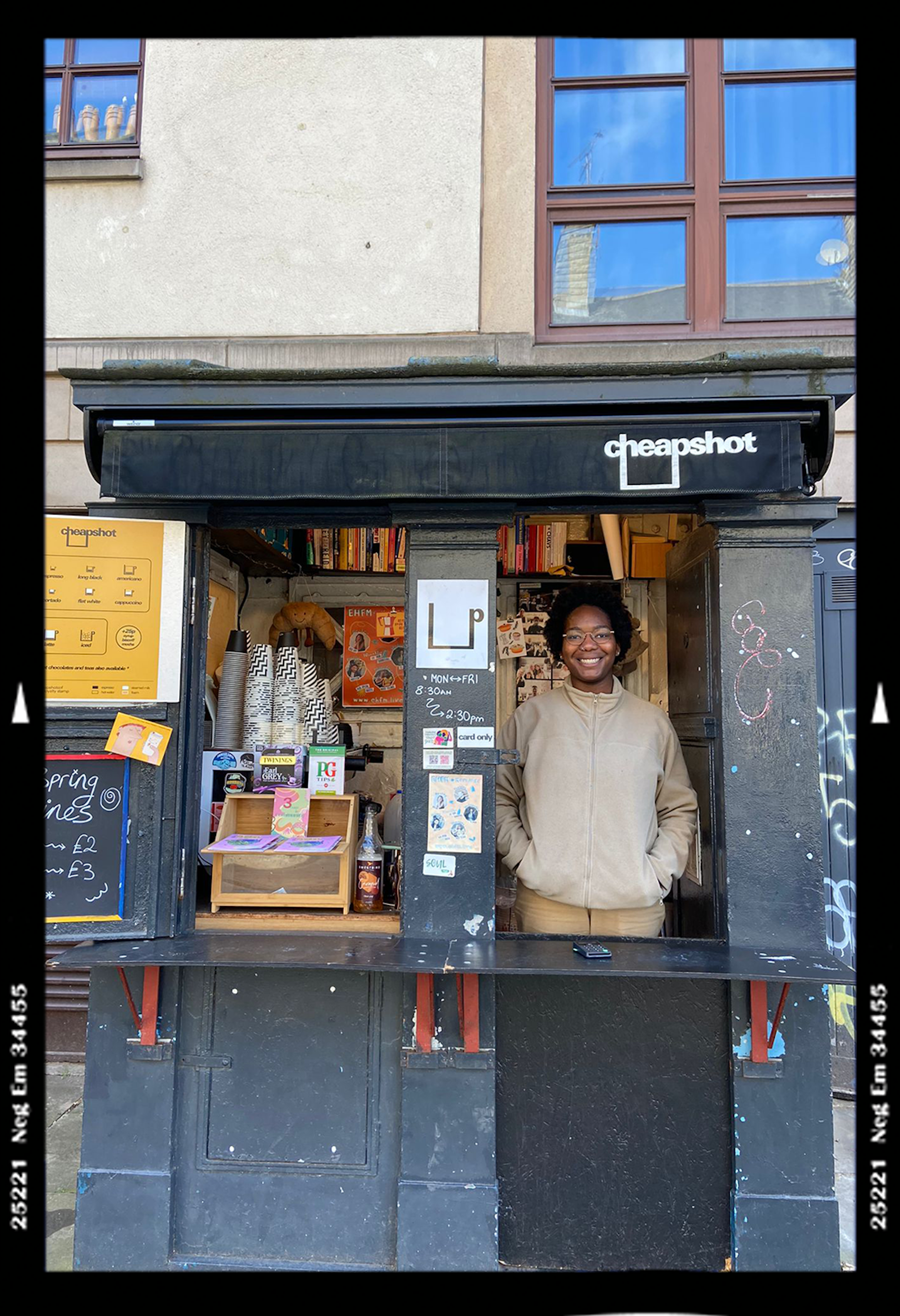 Woman standing at window hatch of coffee shop