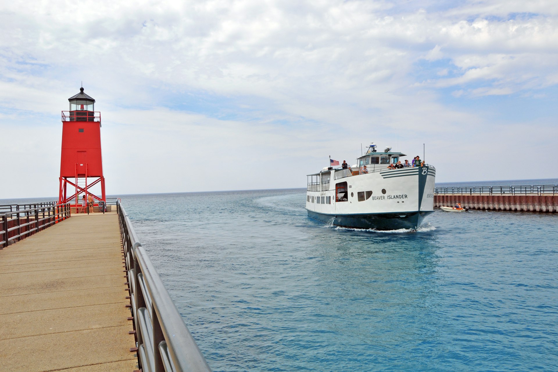 The Beaver Islander ferry passing the Charlevoix South Pier Lighthouse in the Pine River Channel between Lake Michigan and Lake Charlevoix