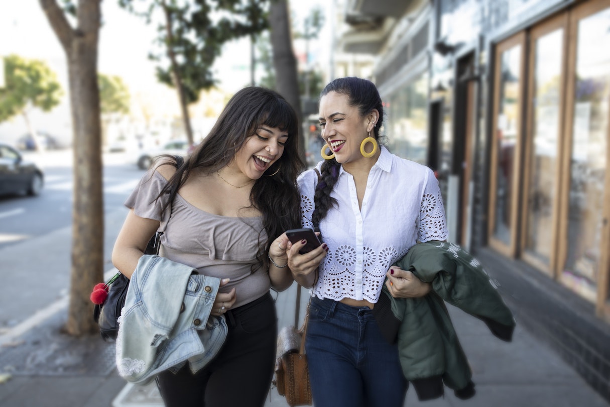 In San Francisco's Mission District, these two millennial generation best friends (lovers, business partners, sisters?) are sharing a moment of laughter while looking at a smartphone. They're leaning close to each other and are confident about where they're going whether to work, to play, to lunch, or to a high-stakes pitch meeting. Their smiles show that they just learned something amazing and they are fully engaged with the moment and each other.
1092349604
togetherness, people, young adult, affectionate, 20-24 years, young couple, enjoyment, lifestyles, cheerful, couple - relationship, friendship, happiness, fun, joy, waist up, carefree, girlfriend, leisure activity, bonding, day, mission district, walking, sidewalk, smart phone, smart casual, technology, skin, earring, latin american and hispanic ethnicity, black hair, braided hair, lace - textile, body positive, portable information device, mobile phone, laughing, smiling, discussion, communication, jeans, shoulder bag, touching, identity, confidence, city life, san francisco - california, the way forward, reflection, attitude, positive emotion, Two People
Two Latina women walking through the Mission District in San Francisco laughing together as check a smartphone