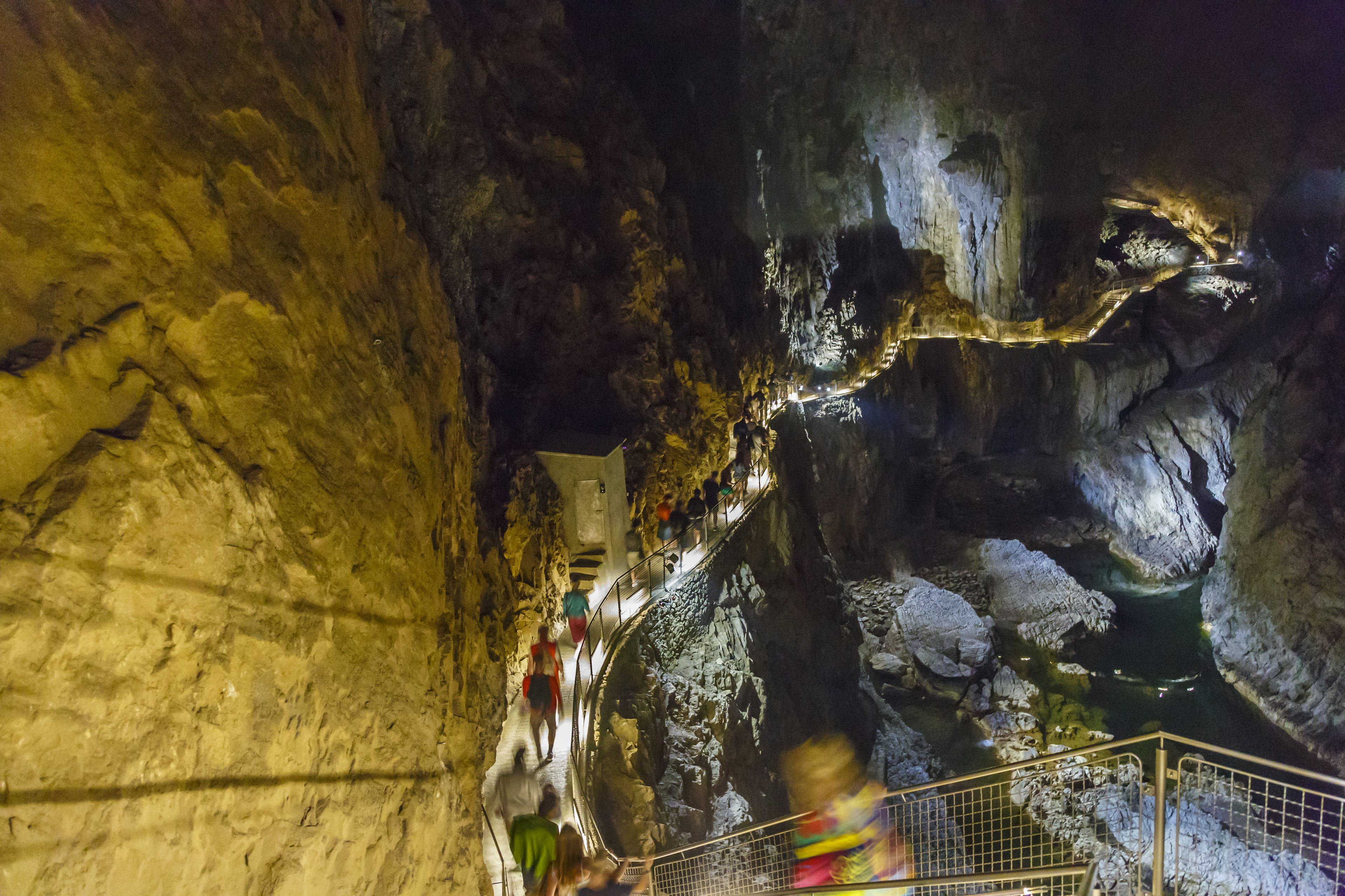 People walk on catwalks through the Škocjan Caves, Inner Carniola region. Slovenia, Europe