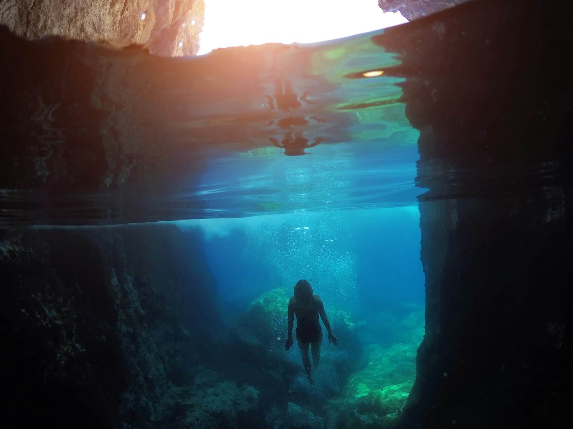 A woman swims underwater near an underwater cave in Florida