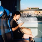 1202312137
A young East Asian woman using her phone on a train in Sicily
