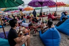 BALI, INDONESIA - JANUARY 28 : Tourists sit on the coloured beanbags under the Balinese umbrellas as they enjoy the sunset at a cafe on January 28, 2021 in Double Six beach, Bali, Indonesia. In Bali, famed among tourists for its beaches and sunsets, the northwest monsoon brings a different kind of arrival - vast amounts of plastic waste. From December to March, so much trash washes up on the beaches that the local government struggles to keep up and clean up. Locals and workers have together been collecting 80 tonnes of waste a day as it washes ashore at world-famous beaches from Seminyak to Kuta, the local government said. Almost 75 percent of it is plastic, according to a study by the Center of Remote Sensing and Ocean Sciences at Bali's Udayana University. In the absence of tourism due to Covid-19, the trash problem has become obvious on beaches almost entirely devoid of visitors. Indonesia is part of the U.N.'s Clean Seas campaign, which aims to halt the tide of plastic trash polluting the oceans. As part of its commitment, the government has vowed to reduce marine plastic waste by 70 percent by 2025. (Photo by Agung Parameswara/Getty Images)
1230981345