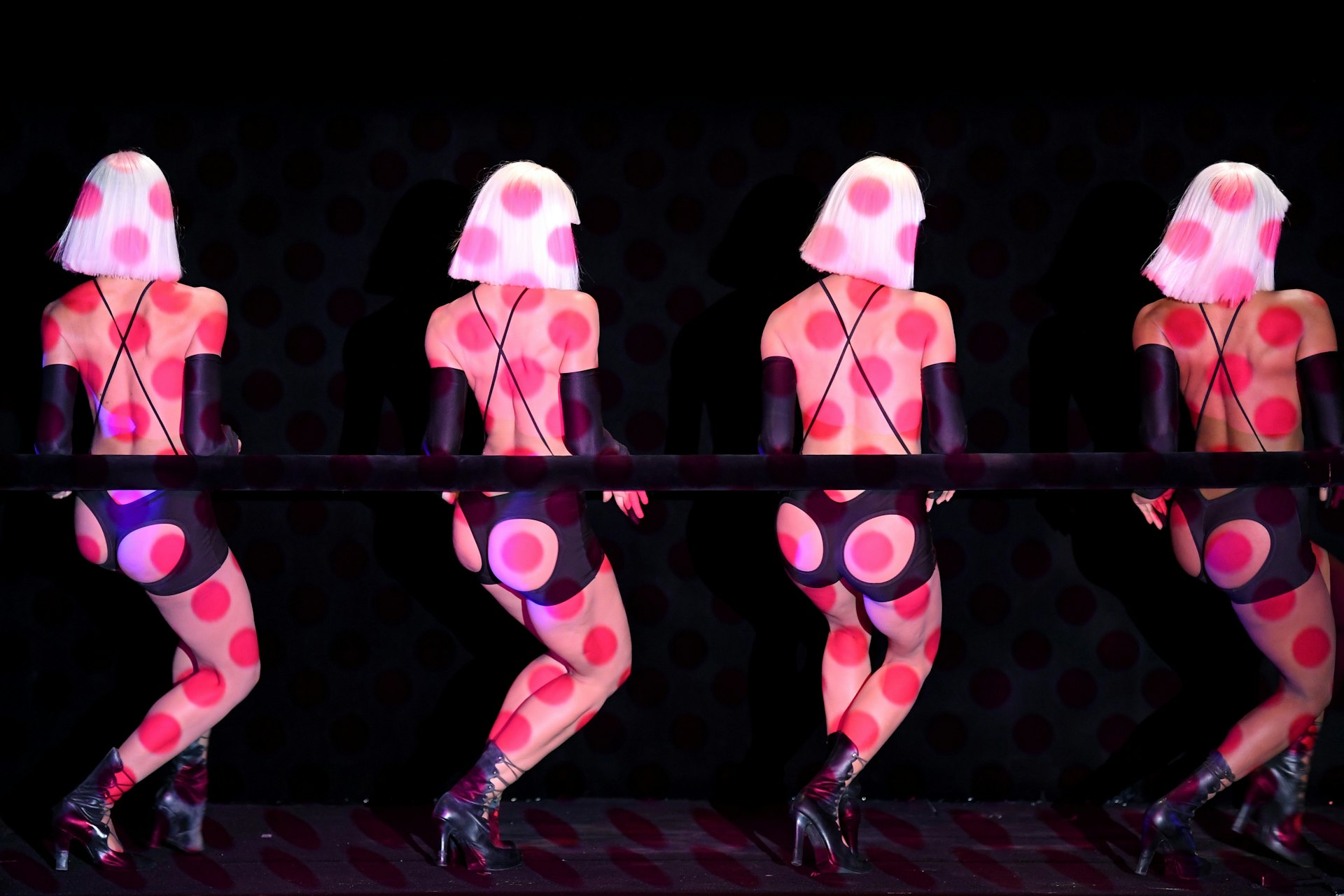 Dancers with polka dot lighting on the stage of the Crazy Horse cabaret, Paris, France