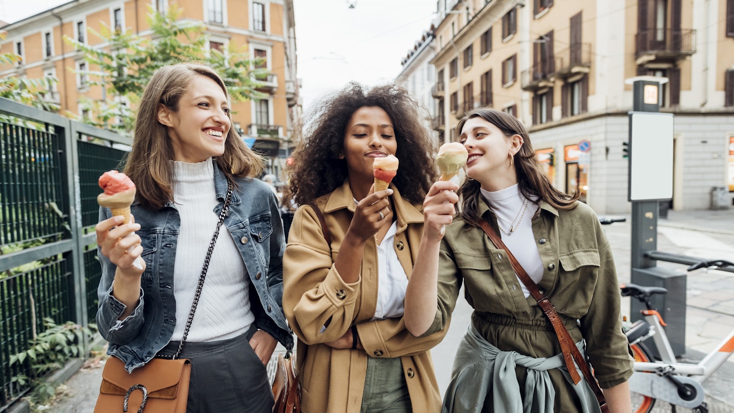 1332178563
casual, ethnic, female, memory, multiethnic, self-portrait, woman
Three smiling women eating ice cream while walking in an Italian city and laughing together