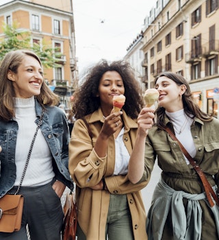 1332178563
casual, ethnic, female, memory, multiethnic, self-portrait, woman
Three smiling women eating ice cream while walking in an Italian city and laughing together
