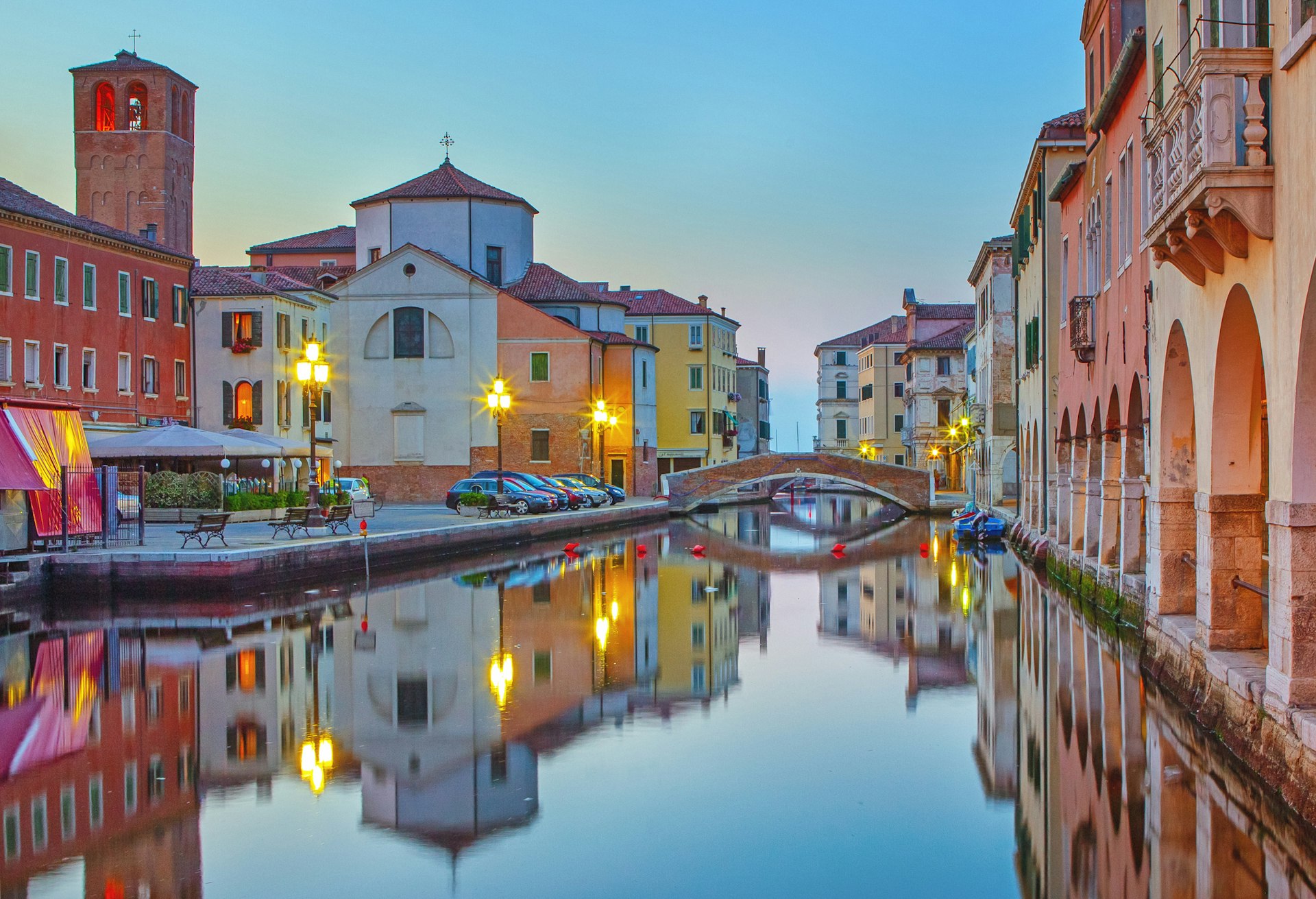 A view of canal Vena at dusk in Chioggia with colorful buildings along each side