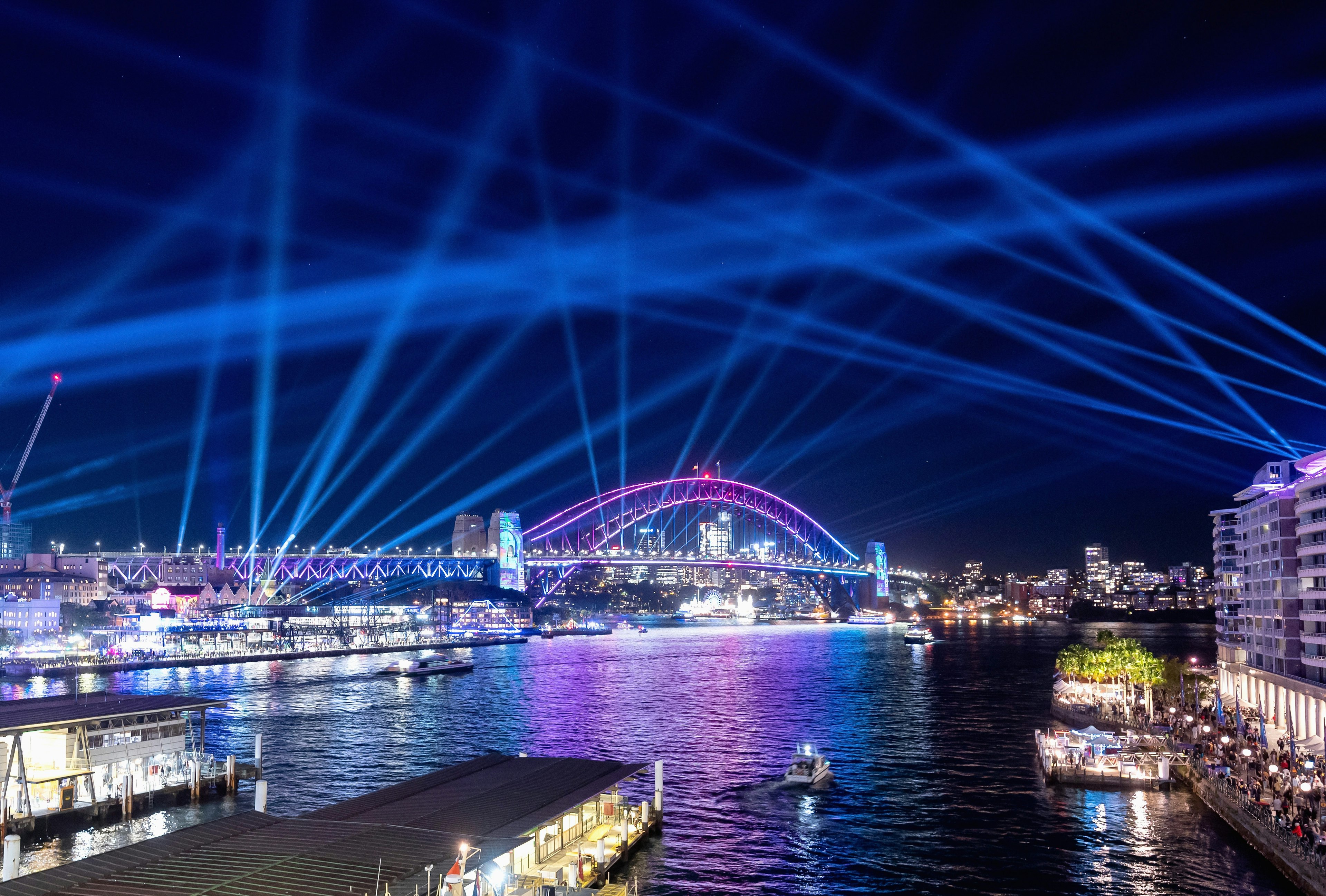 Lights illuminate the Sydney Harbour Bridge and Circular Quay during the 2022 Vivid Sydney festival, Sydney, New South Wales, Australia