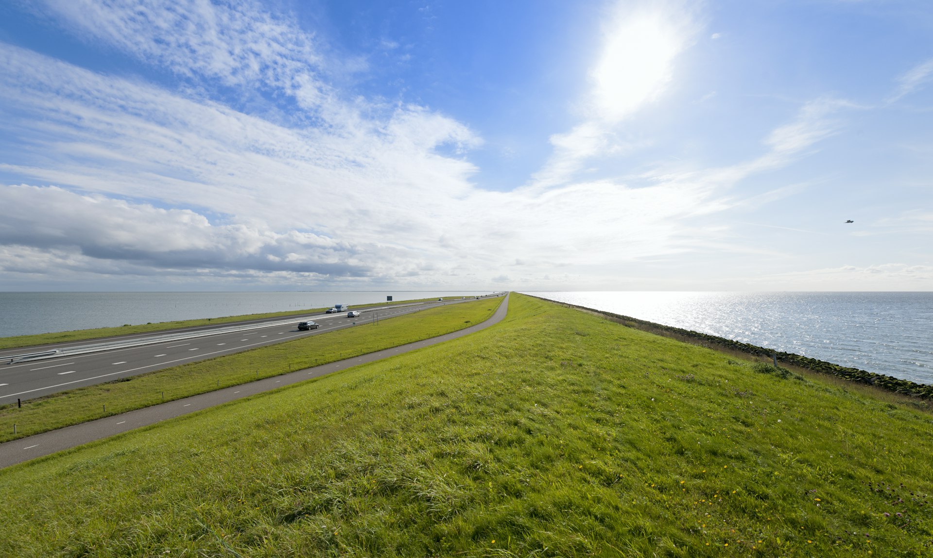 Cars drive along a highway on the Afsluitdijk, North Holland, the Netherlands