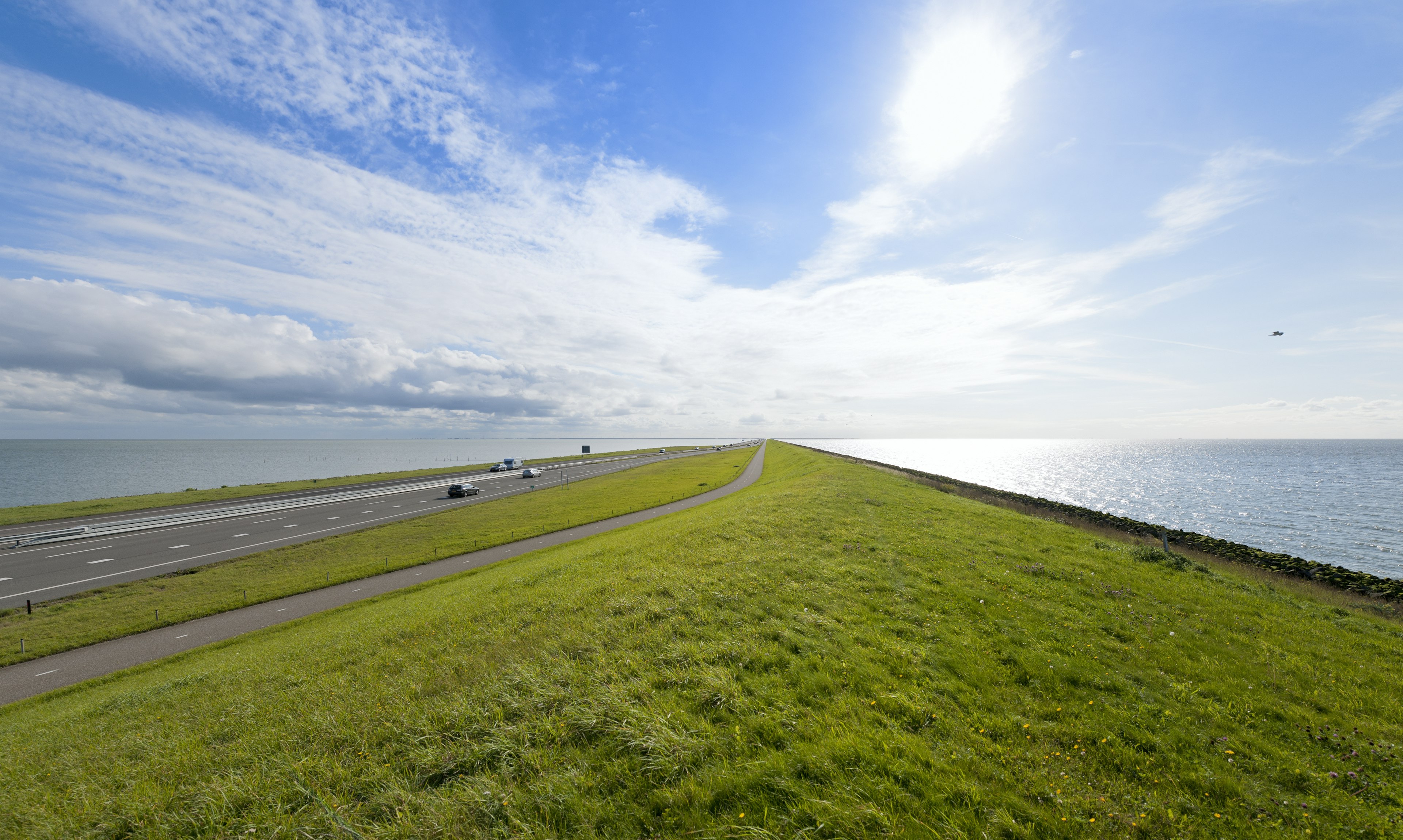 Cars drive along a highway on the Afsluitdijk, North Holland, the Netherlands