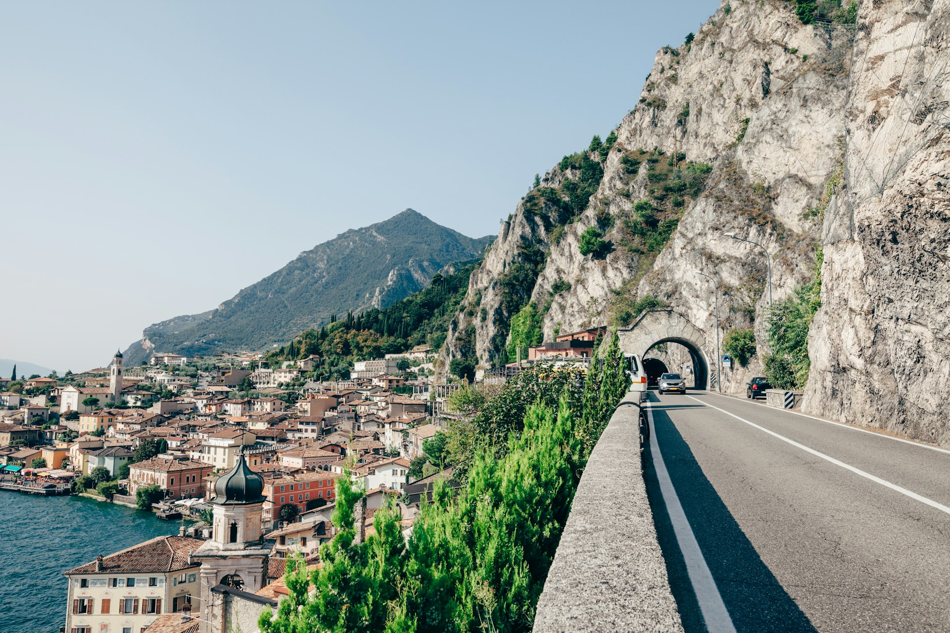 A car driving through a tunnel on a scenic route on Lake Garda and the beautiful village Limone sul Garda, Italy.