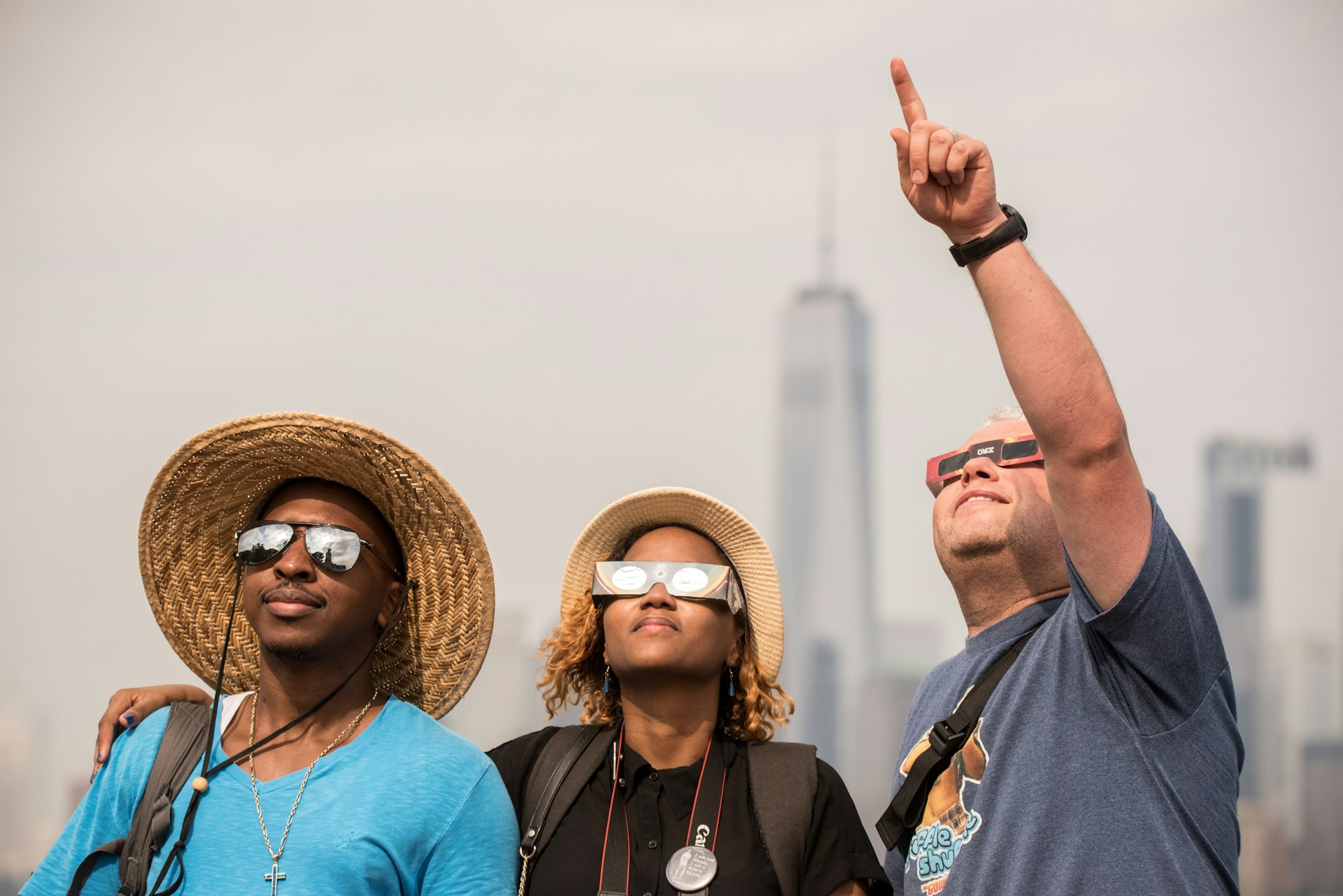 People watch the solar eclipse at Liberty Island on August 21, 2017 in New York City, USA