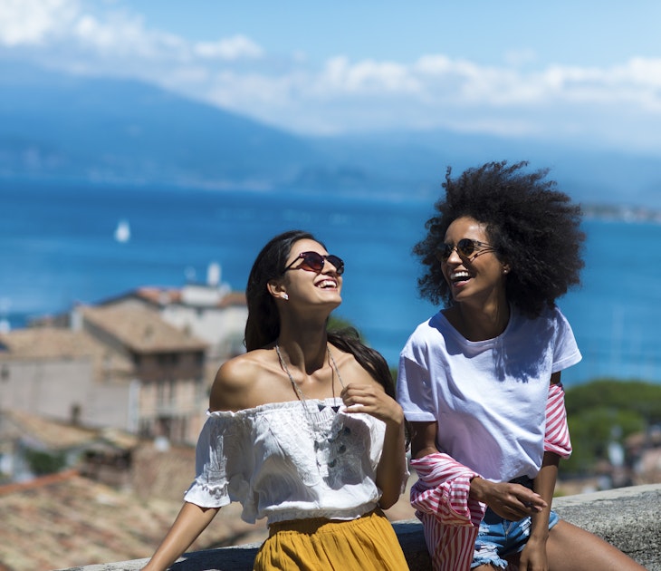 Horizontal picture of two girl friends laughing by the sea side
909521922
Two women laughing together on hilltop overlooking the coast in Italy