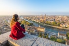 922099688
A young woman admires the view of Verona old town from Castel San Pietro