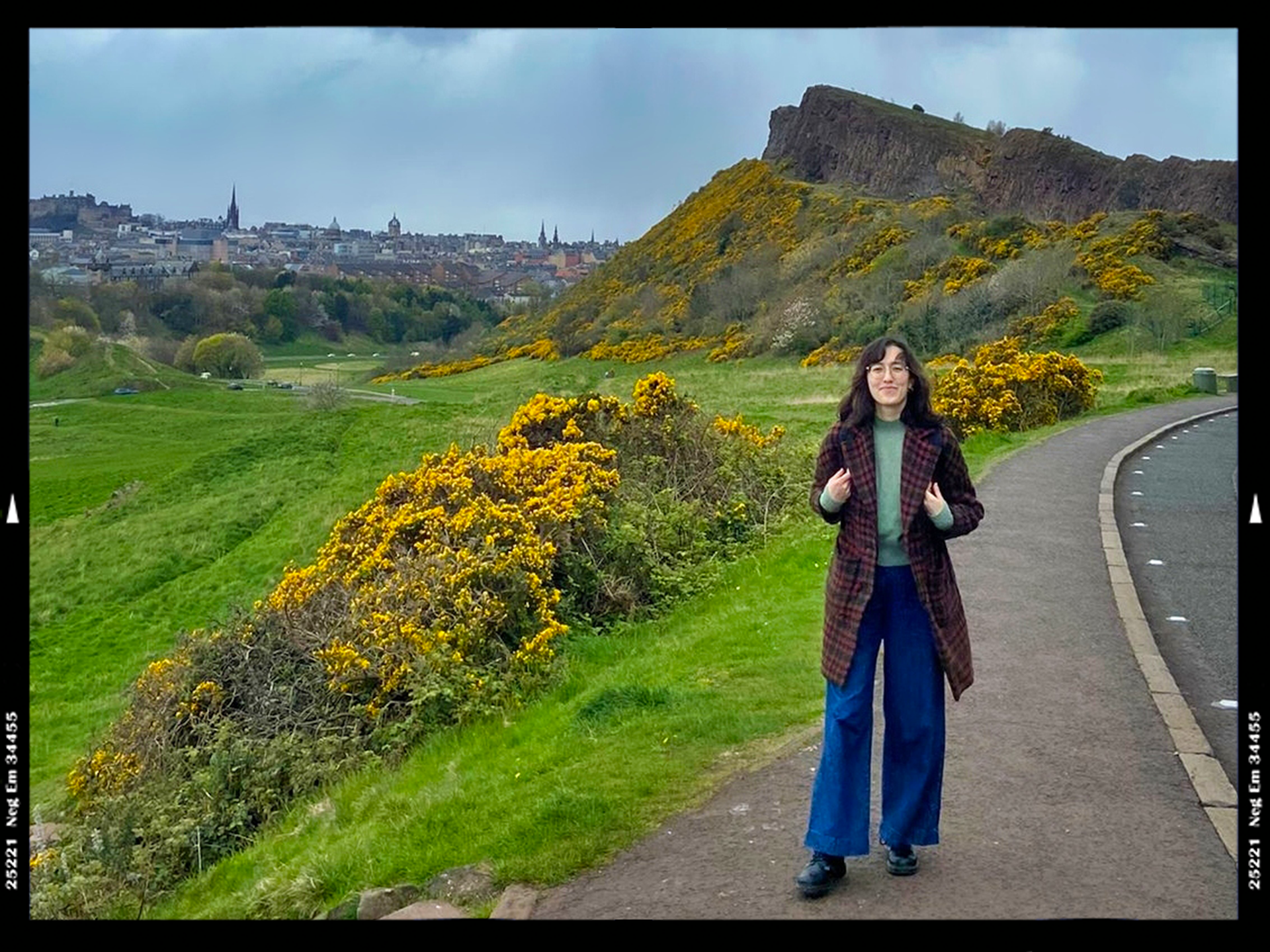 Woman walking in Scotland with Arthur's Seat in background