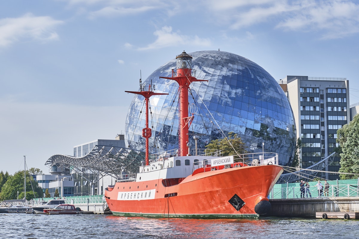 Irbensky, floating lighthouse, museum ship in exposition of Museum of World Ocean over backdrop of Planet Ocean exhibition building on the Pregolya River.