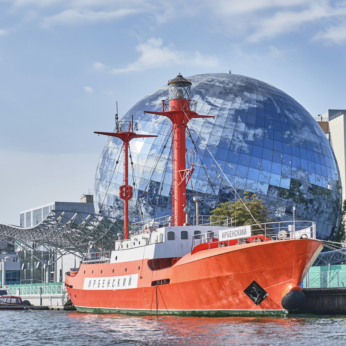 Irbensky, floating lighthouse, museum ship in exposition of Museum of World Ocean over backdrop of Planet Ocean exhibition building on the Pregolya River.
