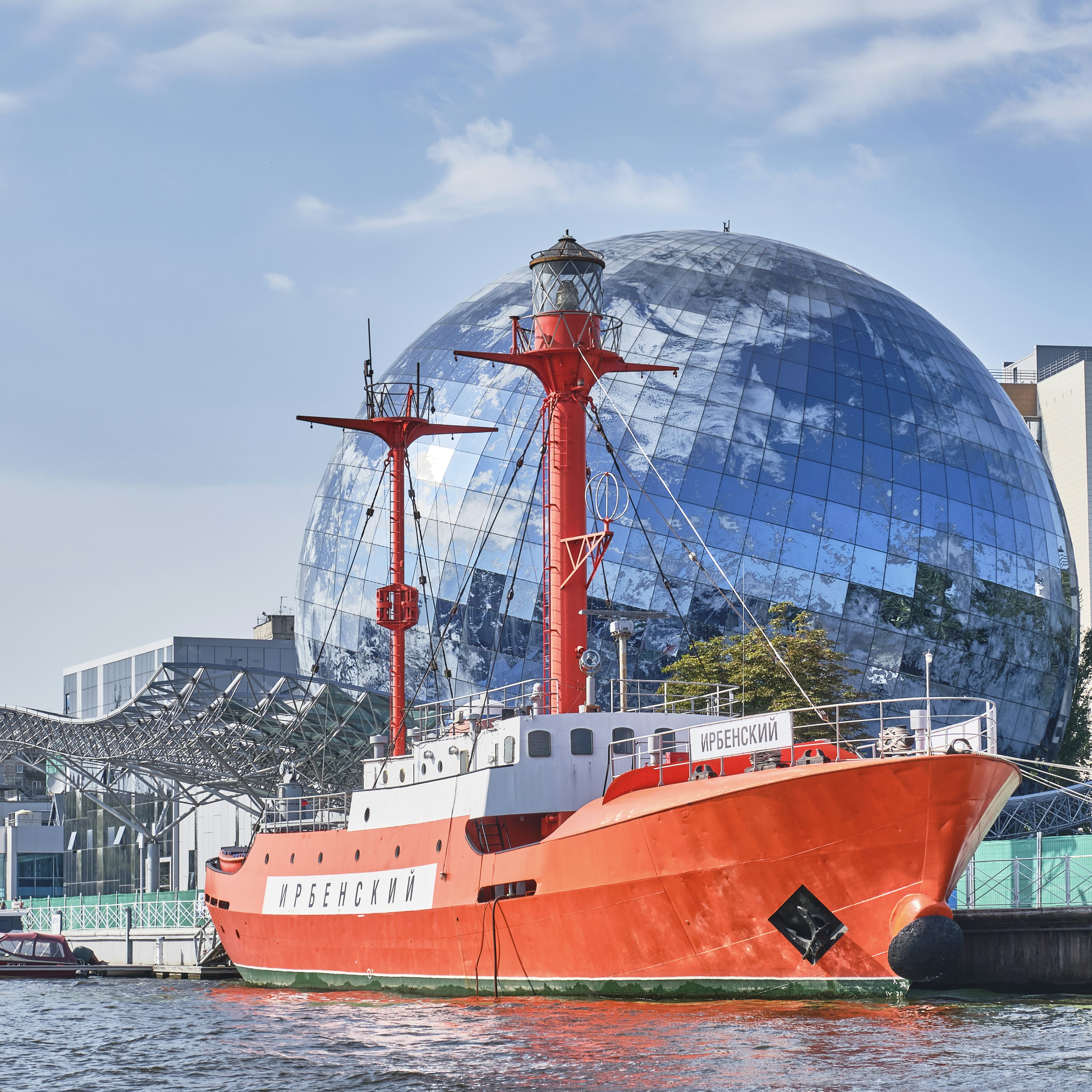Irbensky, floating lighthouse, museum ship in exposition of Museum of World Ocean over backdrop of Planet Ocean exhibition building on the Pregolya River.