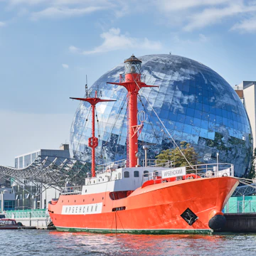 Irbensky, floating lighthouse, museum ship in exposition of Museum of World Ocean over backdrop of Planet Ocean exhibition building on the Pregolya River.