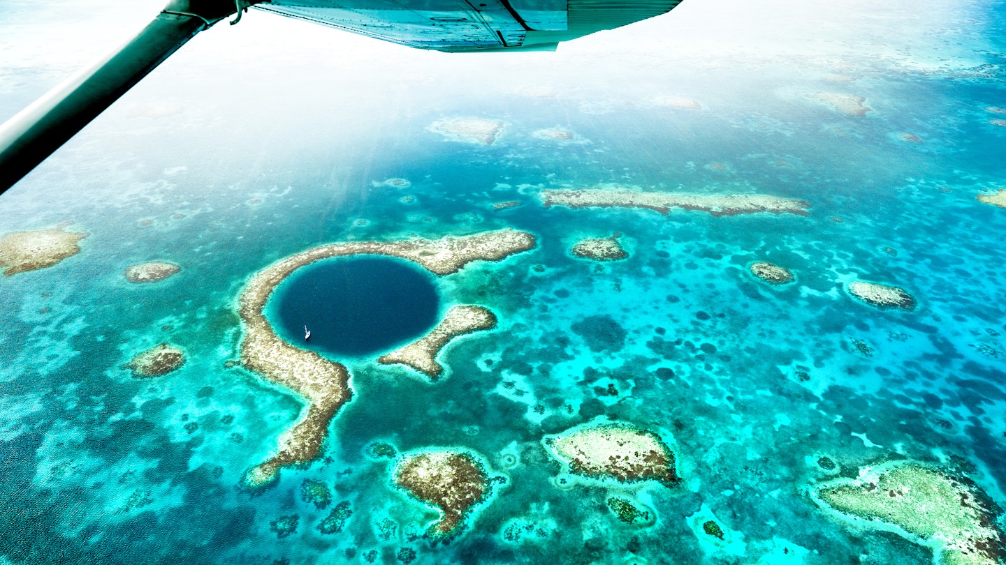 Aerial panoramic view of The Great Blue Hole - Detail of Belize coral reef from airplane excursion - Wanderlust and travel concept with nature wonders on azure vivid filter
1460271564
great