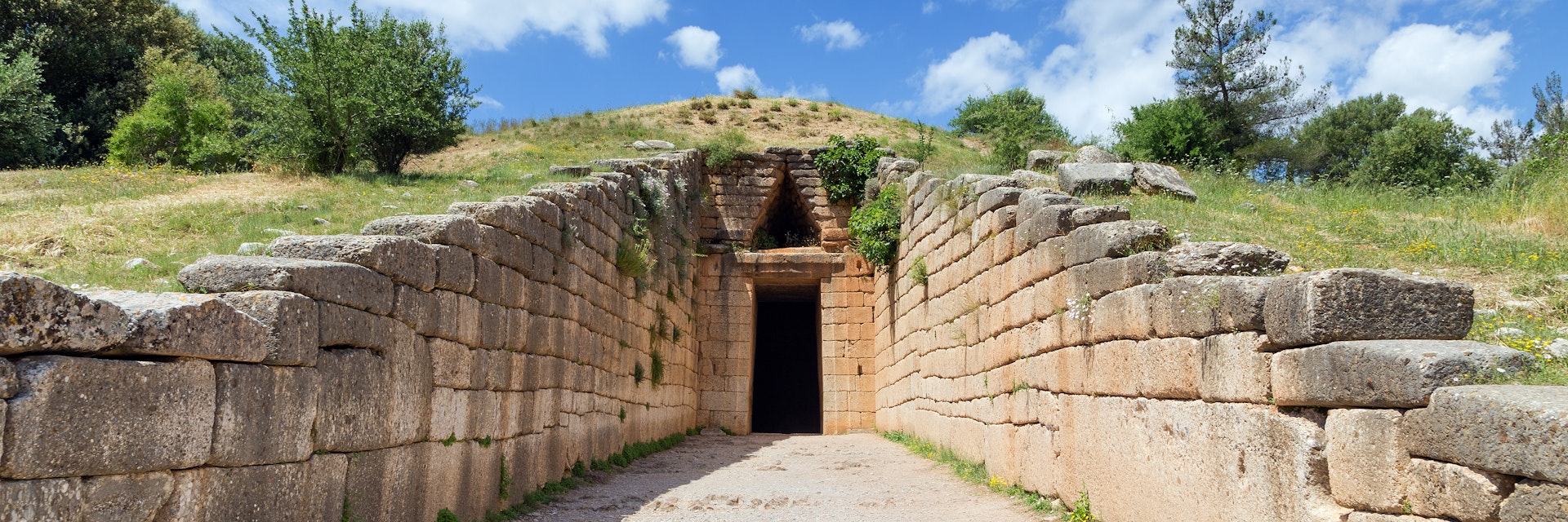 The Treasury of Atreus, or Tomb of Agamemnon, is an impressive "tholos" tomb at Mycenae, Greece, constructed during the Bronze Age around 1250 BC. The lintel stone above the doorway weighs 120 tons, the largest in the world.