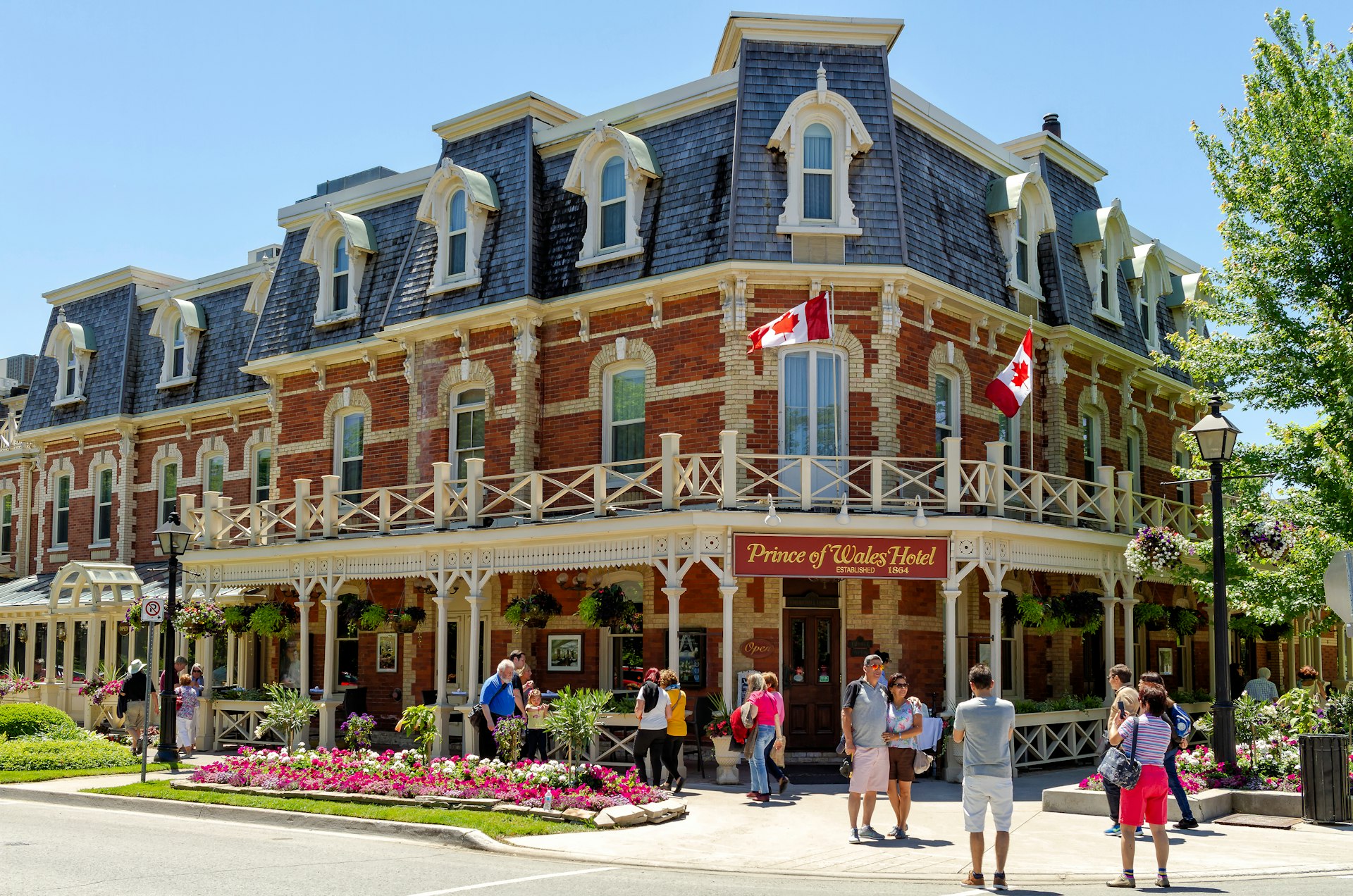 People take pictures in front of the historic, red-brick Prince of Wales Hotel, Niagara-on-the-Lake, Ontario, Canda