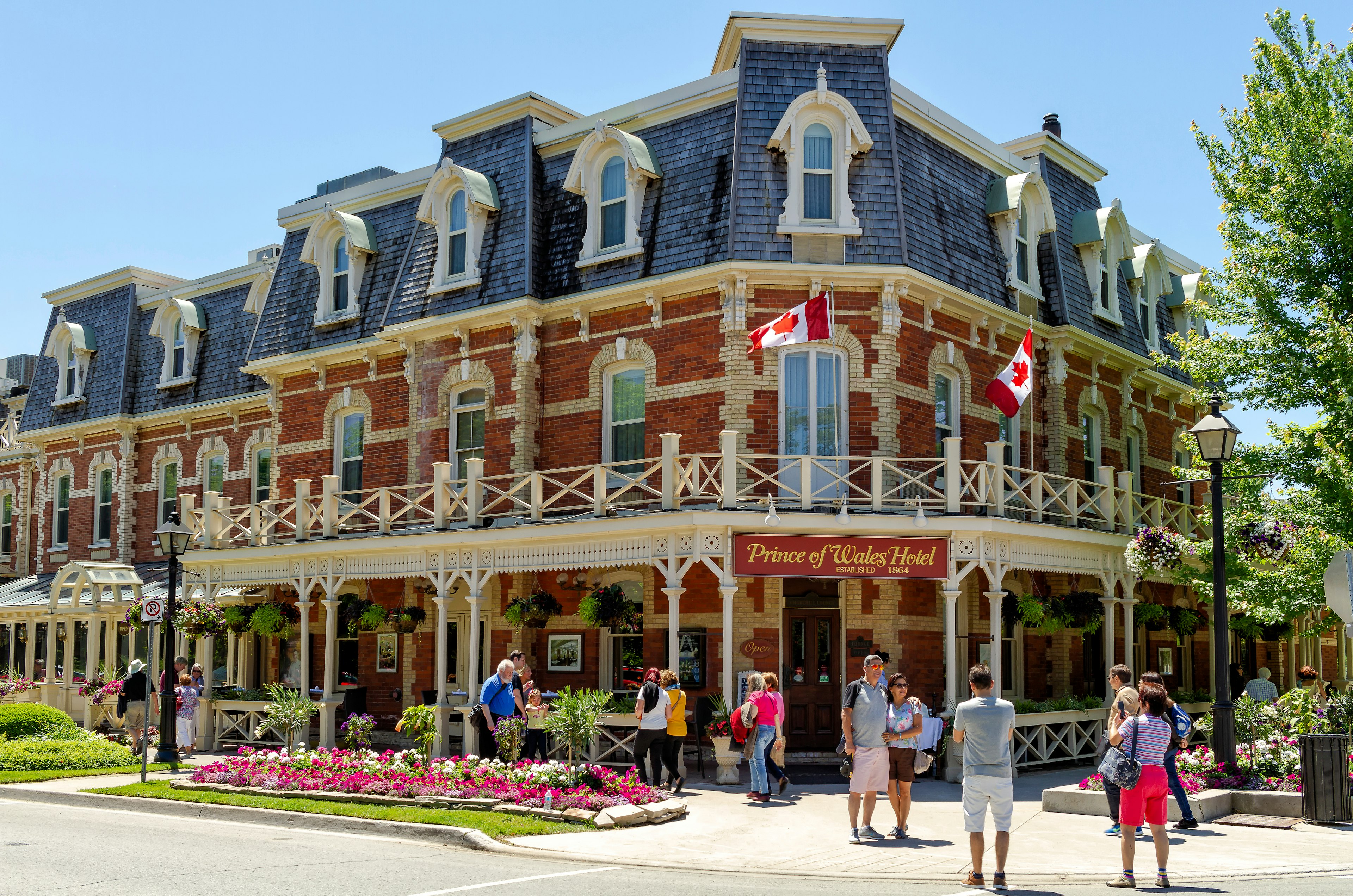 People take pictures in front of the historic, red-brick Prince of Wales Hotel, Niagara-on-the-Lake, Ontario, Canda