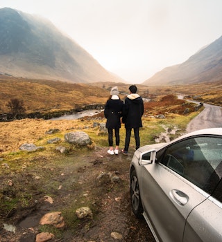 Young couple is relaxing and enjoying the view of mountain filming location of Skyfall Movies After The Rain, Glencoe valley, Scotland.; Shutterstock ID 495640633; your: Claire Naylor; gl: 65050; netsuite: Online ed; full: Scotland road trips
495640633