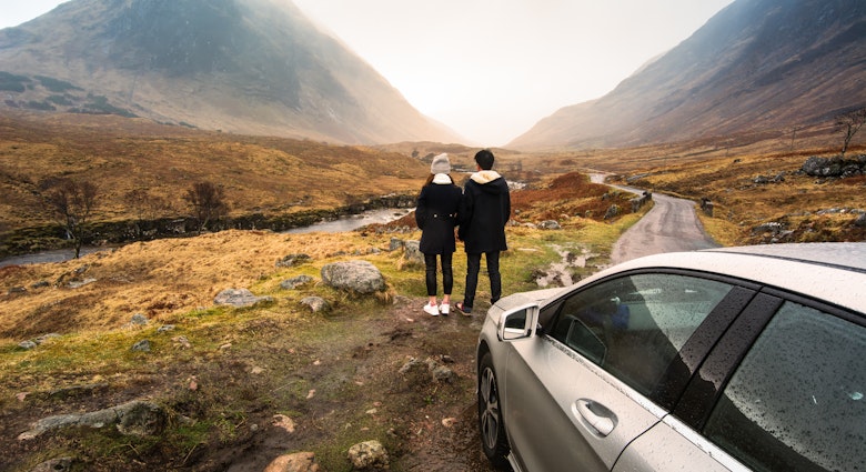 Young couple is relaxing and enjoying the view of mountain filming location of Skyfall Movies After The Rain, Glencoe valley, Scotland.; Shutterstock ID 495640633; your: Claire Naylor; gl: 65050; netsuite: Online ed; full: Scotland road trips
495640633