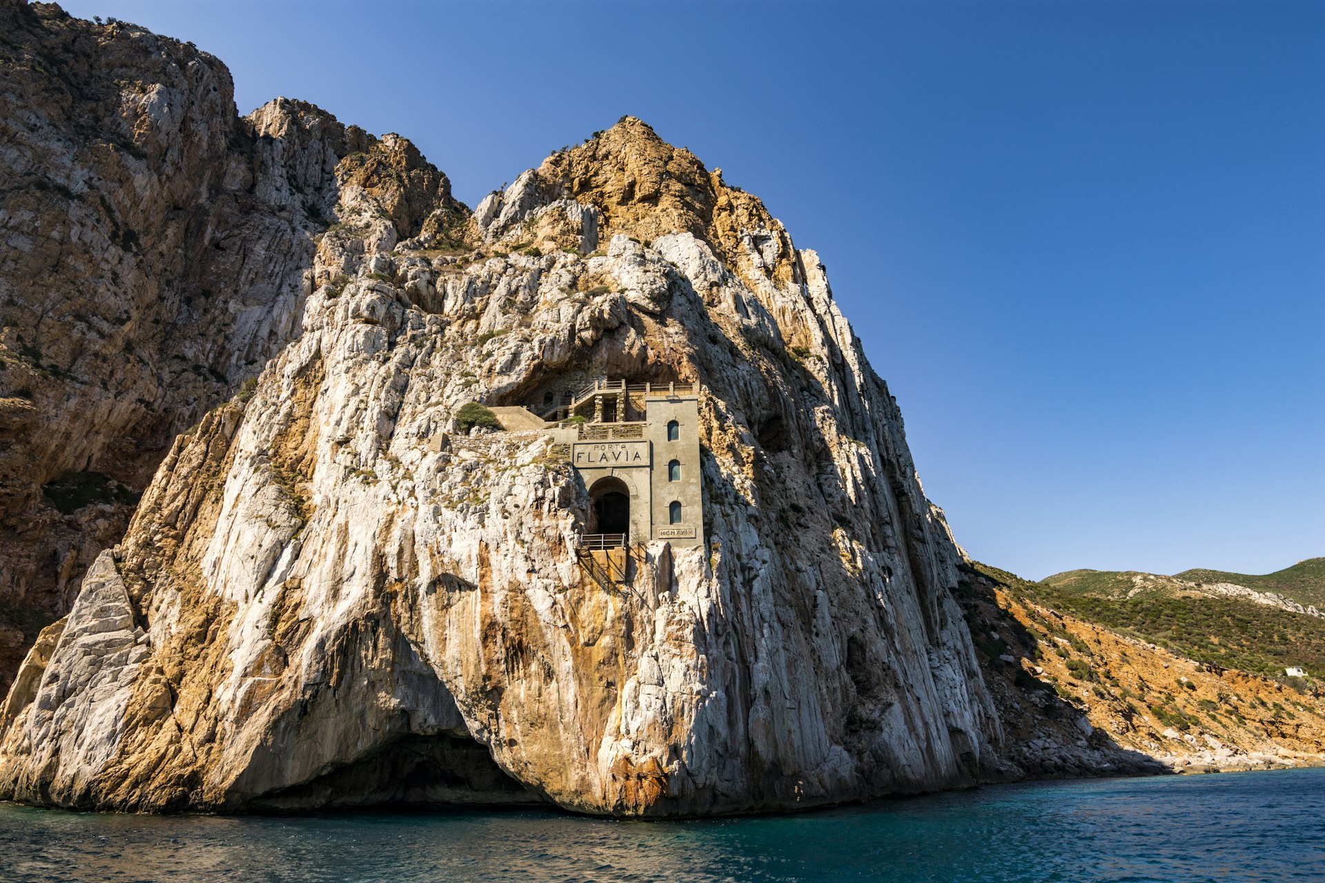 A mine entrance built into a sea cliff