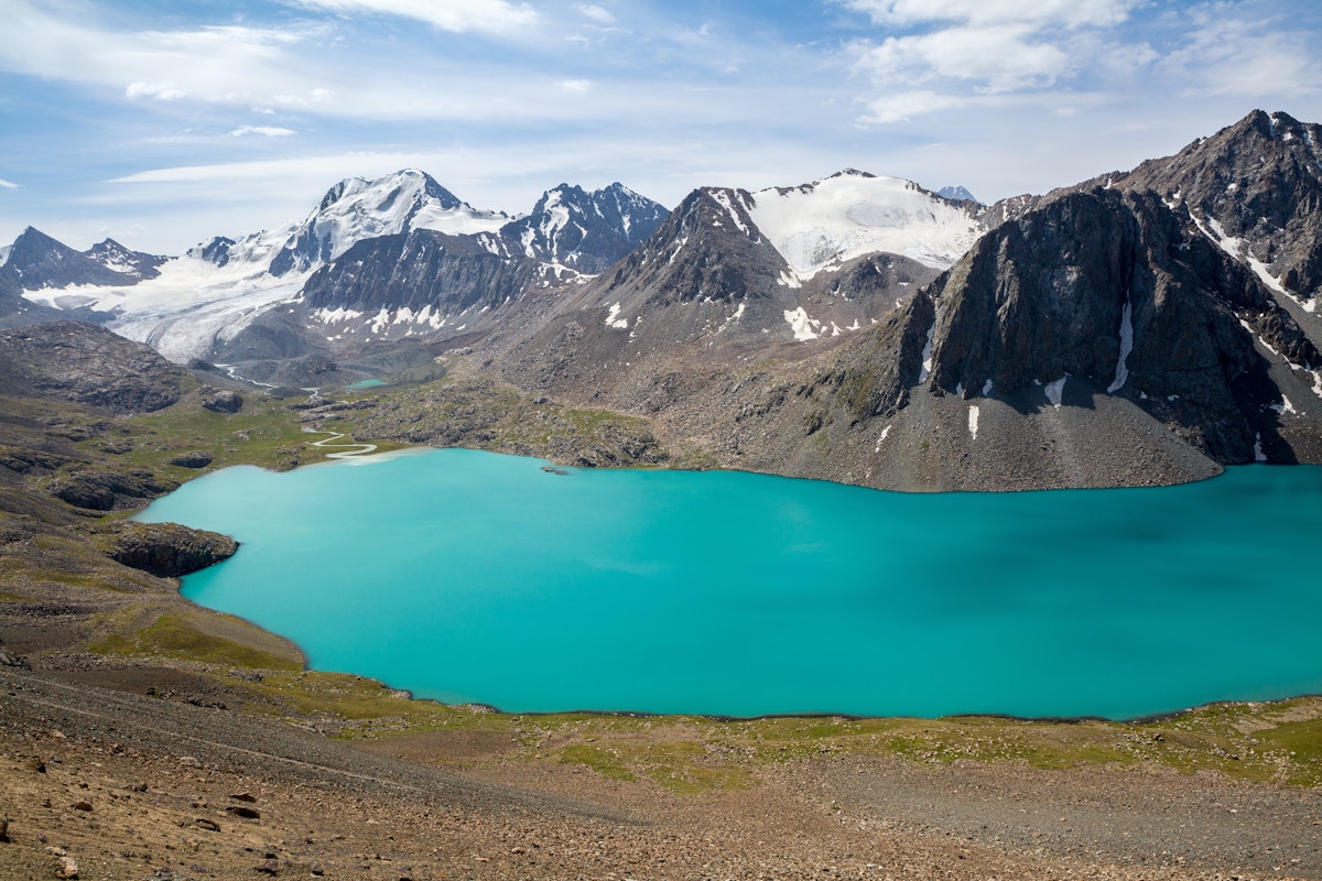 Ala-Kul lake and snow-capped mountains in Kyrgyzstan.
