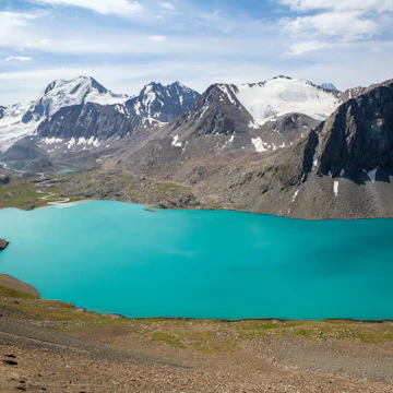 Ala-Kul lake and snow-capped mountains in Kyrgyzstan.