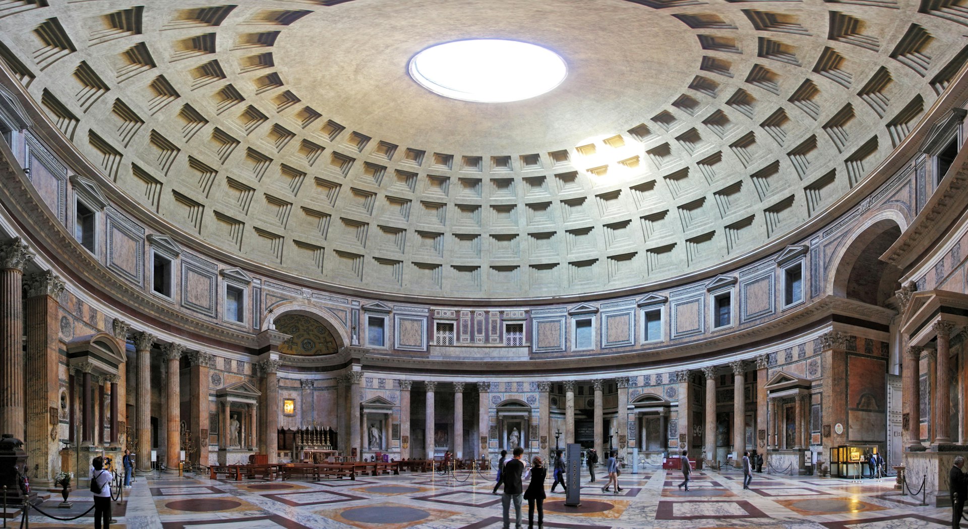 The interior of the Pantheon with light flooding through the opening in the roof of its vast dome
