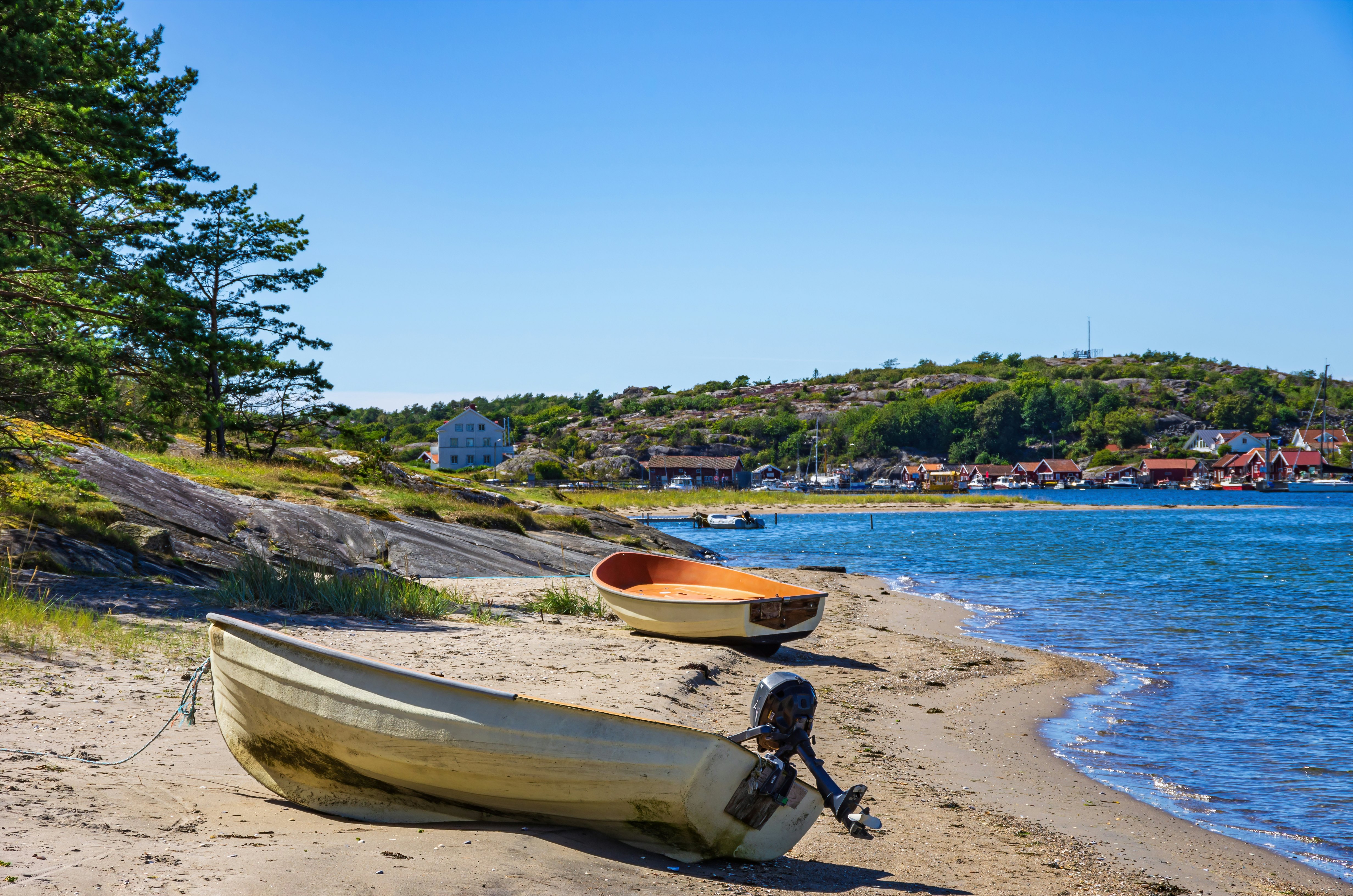 Two boats lie ashore on the North shore of South Koster Island (Sydkoster) with a view of the North Koster Island (Nordkoster) in Sweden.
