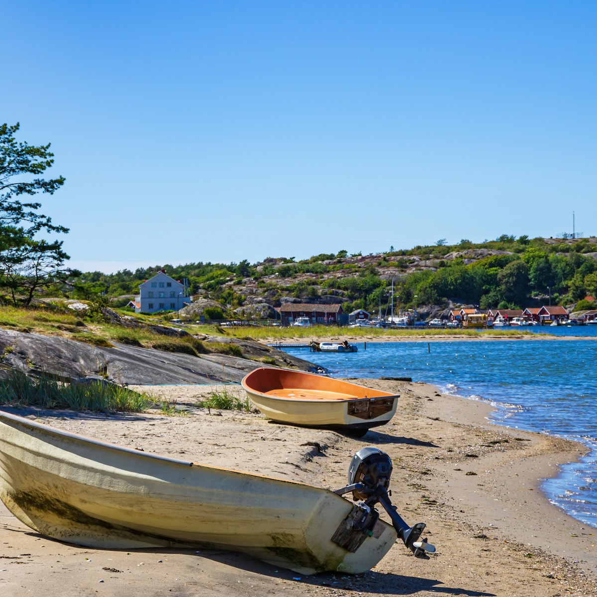 Two boats lie ashore on the North shore of South Koster Island (Sydkoster) with a view of the North Koster Island (Nordkoster) in Sweden.