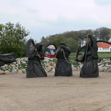 Sculpture of the three norns at the Ribe Vikingecenter.