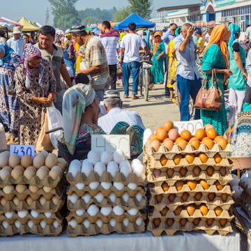 Eggs for sale and a crowd of people visiting Kumtepa bazaar.