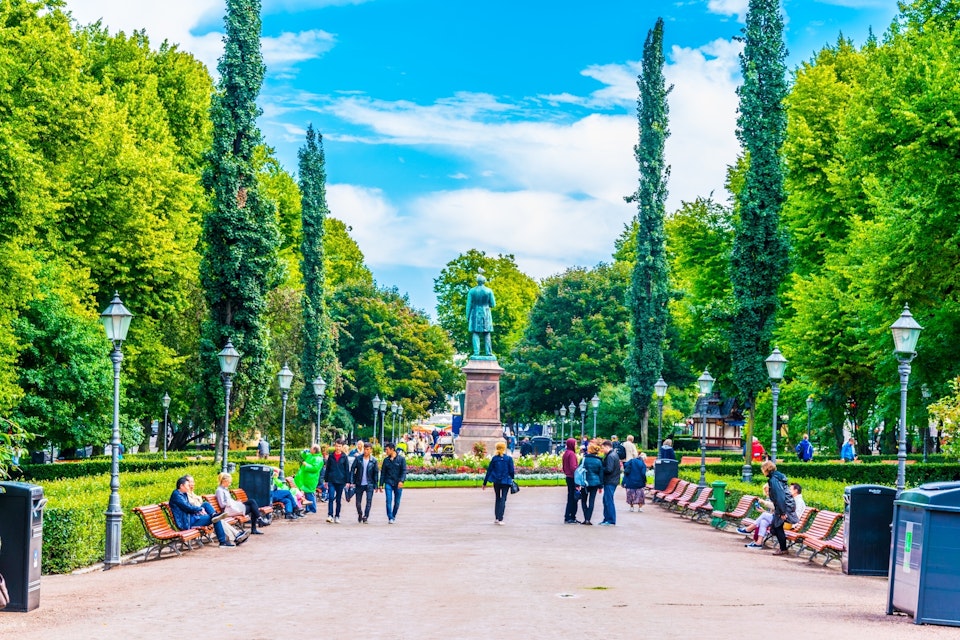 People strolling through Esplanadin puisto - Esplanade park in central Helsinki, Finland.