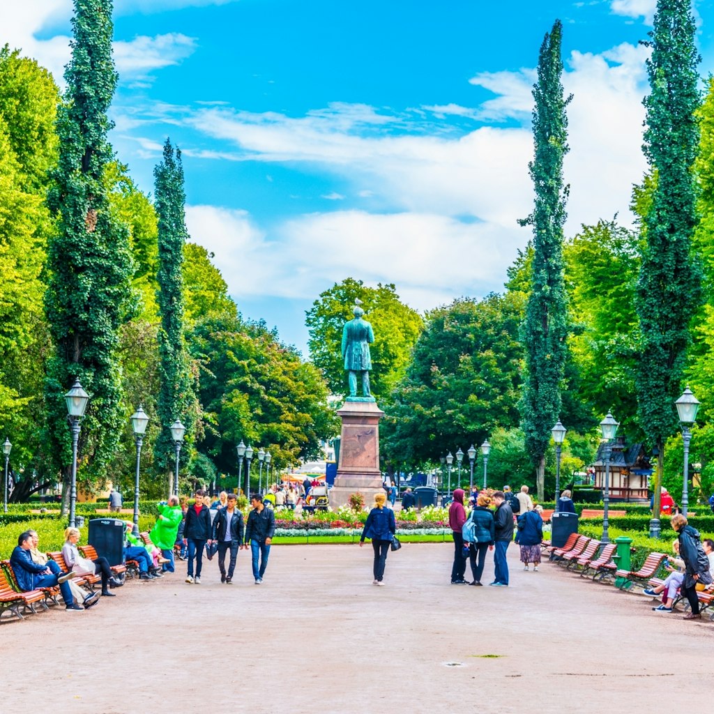 People strolling through Esplanadin puisto - Esplanade park in central Helsinki, Finland.