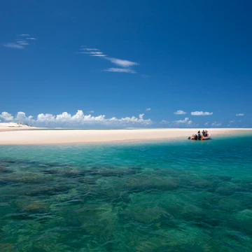 Mozambique, Bazaruto Archipelago. Divers kit up on a zodiac, ready to explore the stunning coral reefs off Benguerra Island.