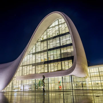 Exterior of Heydar Aliyev center (designed by Zaha Hadid) at night.