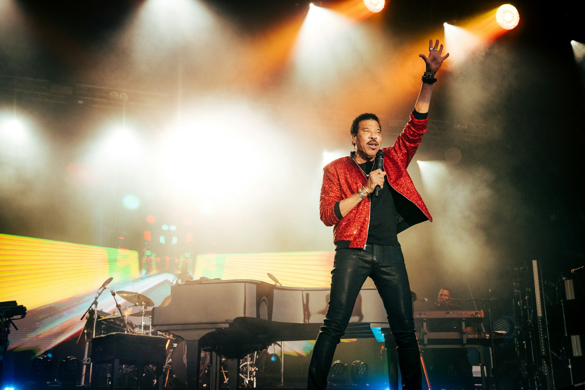 Lionel Richie in a red jacket performing at Cambridge Club festival in 2023