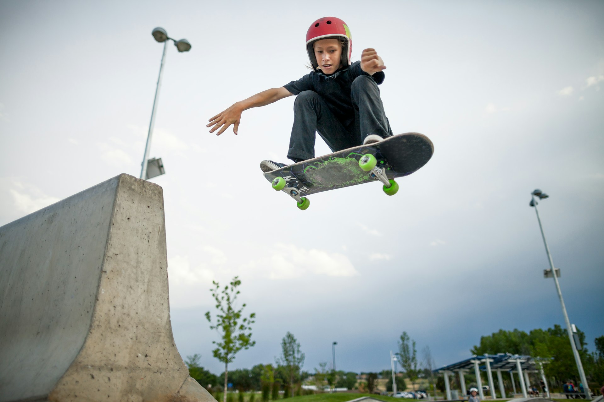 A kid airborne on a skateboard at Confluence Park, Denver